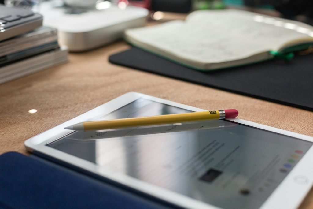 Tablet and stylus on desk. 