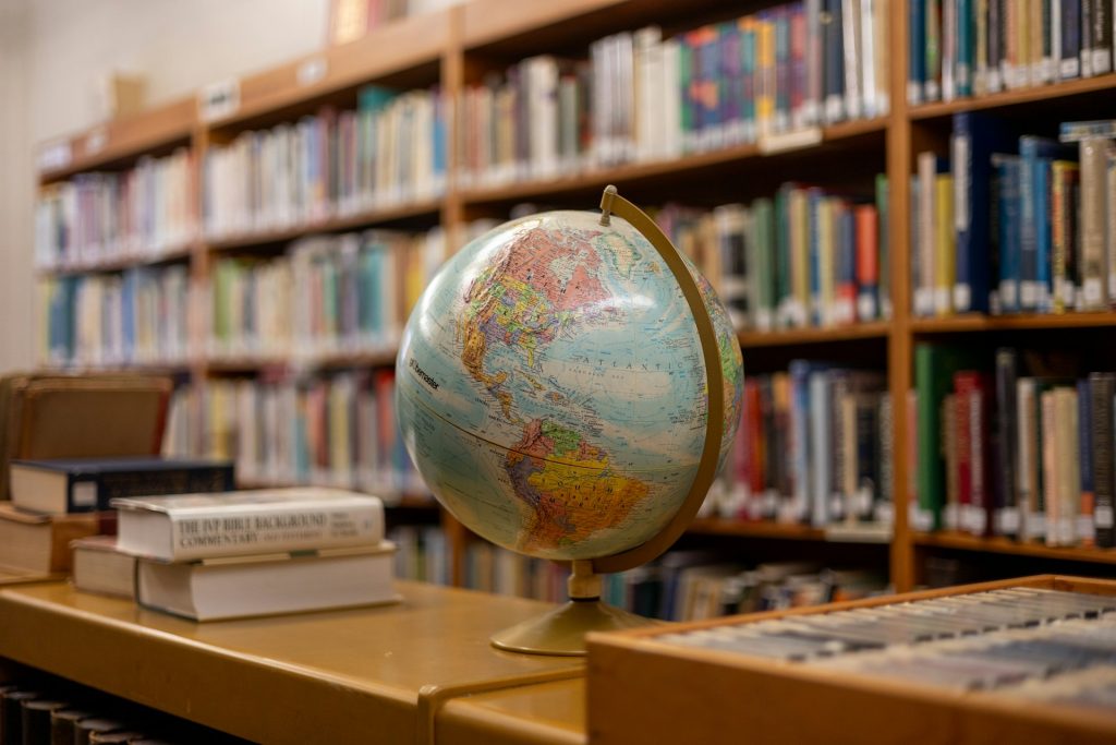 Globe standing on desk in library.