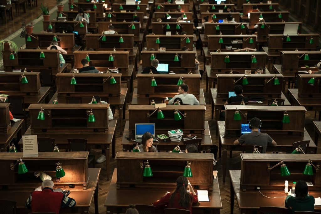 University library with students sitting in cubicles. 