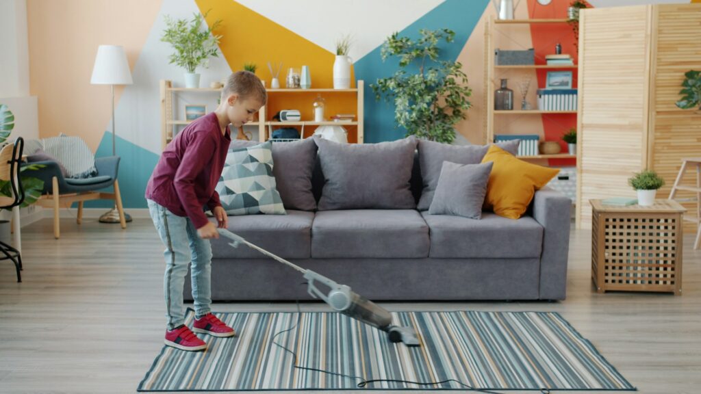 boy vacuuming living room