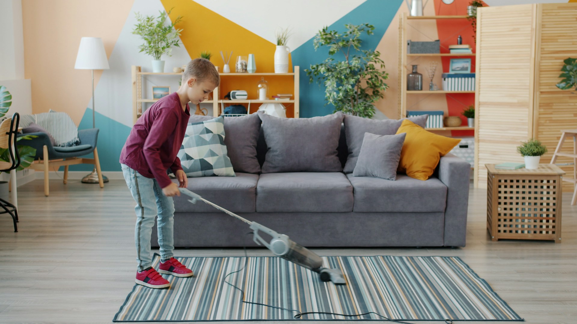 boy vacuuming living room